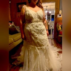 Brand new with tags plus size wedding dress and belt/sash included